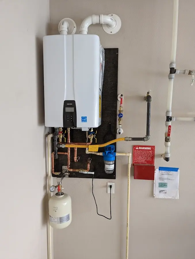 Professional plumber installing copper piping in a Elmendorf home